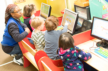 Pre-schoolers learning computing at their computer suit.